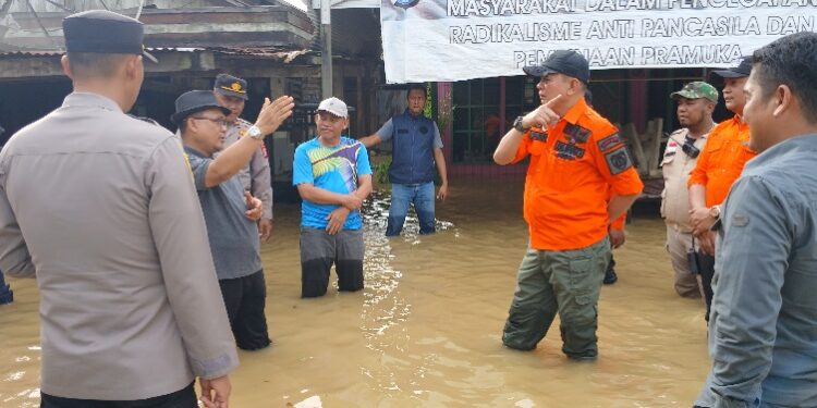Bupati Barito Timur M. Yamin, didampingi jajaran BPBD Damkar, dan unsur Forkopimcam, berdialog dengan warga terdampak banjir saat meninjau lokasi banjir di Kelurahan Ampah Kota, Kecamatan Dusun Tengah, Minggu (28/12/2025).