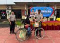 Kapolsek Dusun Tengah, IPTU Suprayitno, yang membagikan takjil kepada warga melintas di depan Mapolsek.