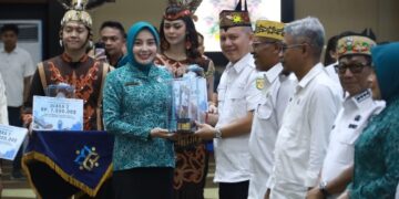 Ketua TP PKK Kalteng, Aisyah Thisia Agustiar Sabran, menyerahkan penghargaan kepada kepala daerah yang telah menyelesaikan dokumen Peta Jalan Pembangunan Kependudukan (PJPK) 2025–2029 serta penilaian kinerja stunting tahun 2025.