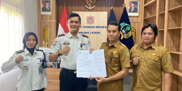 Kepala Rutan Tamiang Layang, Agung Novarianto, dan perwakilan DPK Barito Timur, memperlihatkan MoU kerjasama yang telah ditandatangani.