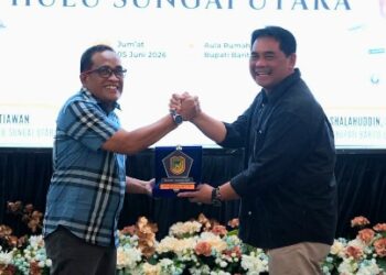 Bupati Barito Utara H. Shalahuddin, dan Bupati Hulu Sungai Utara, H. Sahrujani, bertukar plangkat daerah dalam pertemuan silahturahmi, Jumat (5/6/2026).